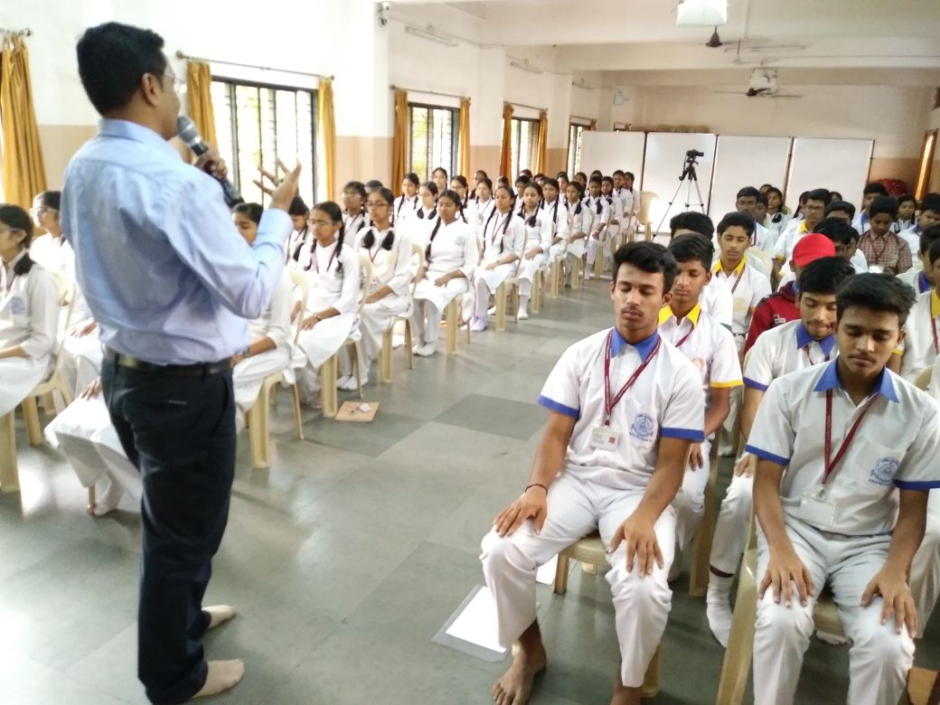 Career guidance consultation in Mumbai — Dr. Rahul Sawant discussing a study plan and career options chart with a Class 8 student and his mother in Malad East